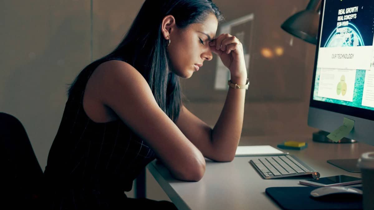woman sitting at desk experiencing burnout